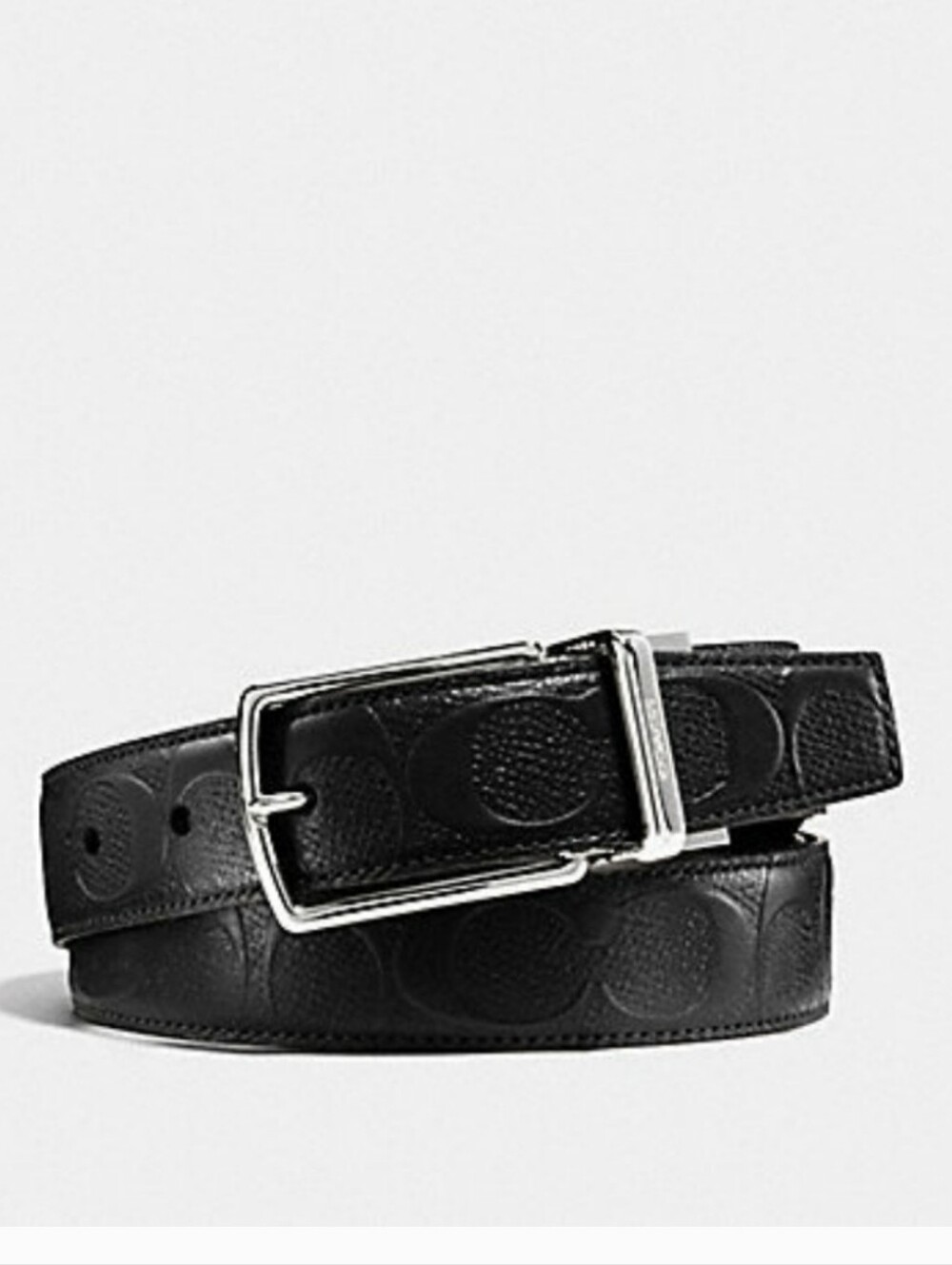 Black leather Coach belt. Reversible embossed Coach signature logo on one side.